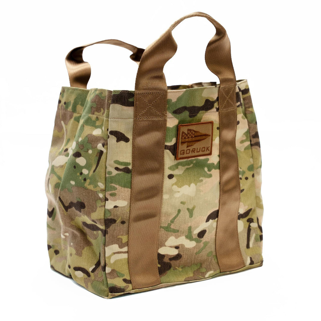 GORUCK camouflage tote bag with sturdy brown handles on white background