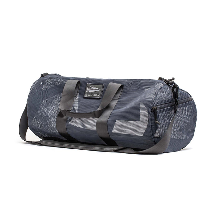 The Mesh Gym Bag features a dark gray design with black handles, zippered pockets, and an adjustable shoulder strap.