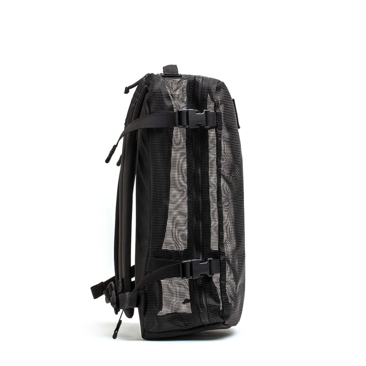 GORUCK black mesh rucking backpack with compression straps, side view on white background