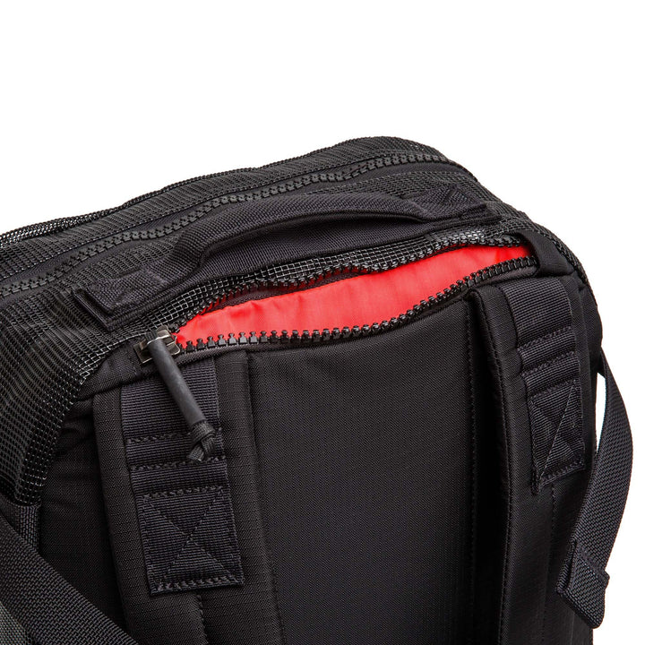 GORUCK black rucking backpack with open zipper and red interior detail