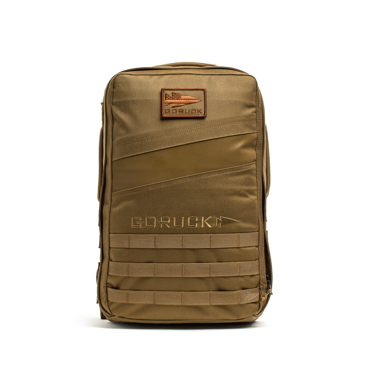 The GORUCK Rucker 4.0 is a khaki rectangular bag featuring a front zipper, visible branding, and a patch.