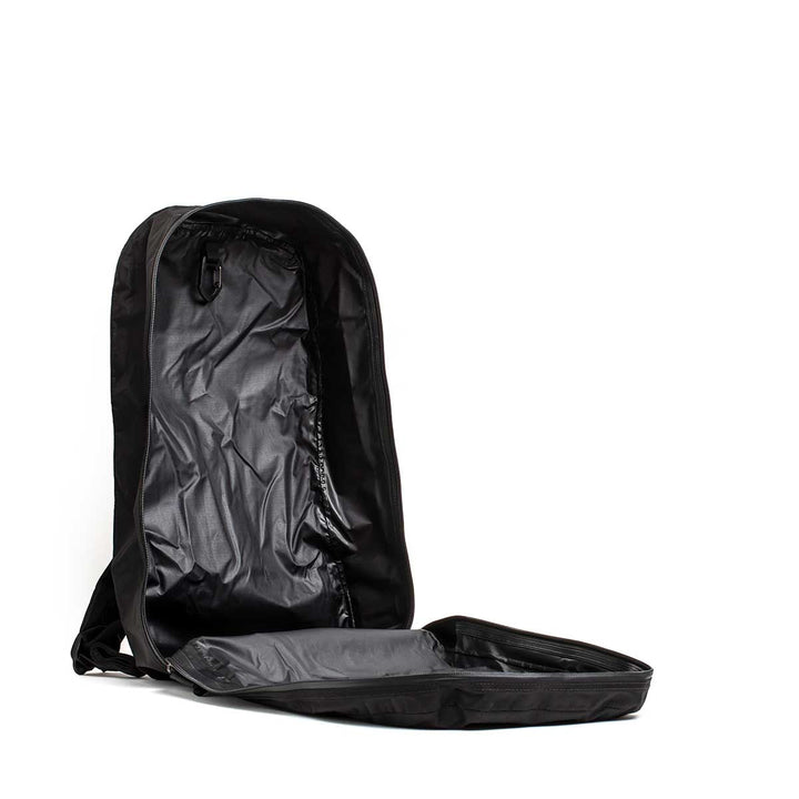 The Packable Bullet Ruck - Ripstop ROBIC® is shown lying on its back, lightweight and empty, with its main compartment unzipped and fully open.