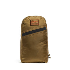 The GORUCK Packable Bullet Ruck - Ripstop ROBIC® is a lightweight brown backpack featuring a zippered design, a black diagonal stripe, and a rectangular GORUCK patch on the front—perfect for daily use or quick adventures.