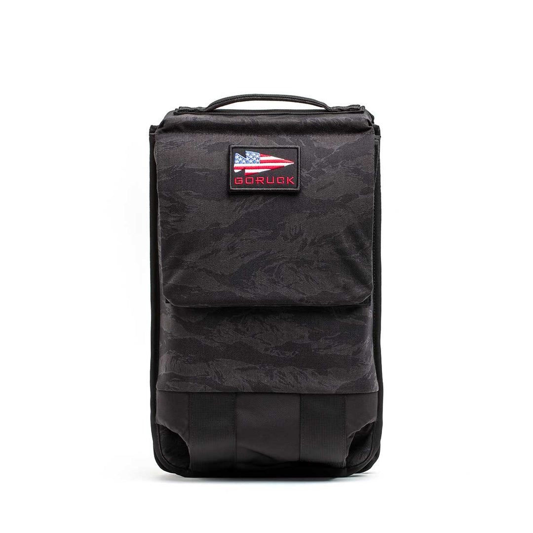 The black GORUCK Ruck Plate Carrier 3.0, shown with a USA flag patch against a white backdrop, is perfect for your workout gear or as a versatile ruck plate carrier.