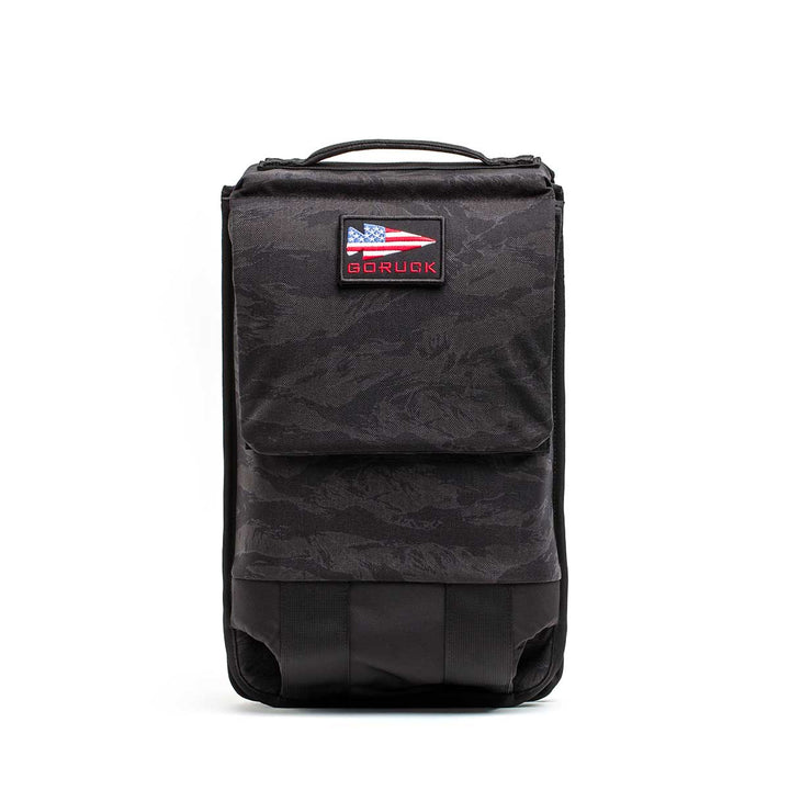 The black GORUCK Ruck Plate Carrier 3.0, shown with a USA flag patch against a white backdrop, is perfect for your workout gear or as a versatile ruck plate carrier.