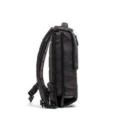 Side view of GORUCK black tactical rucksack with padded straps on white background
