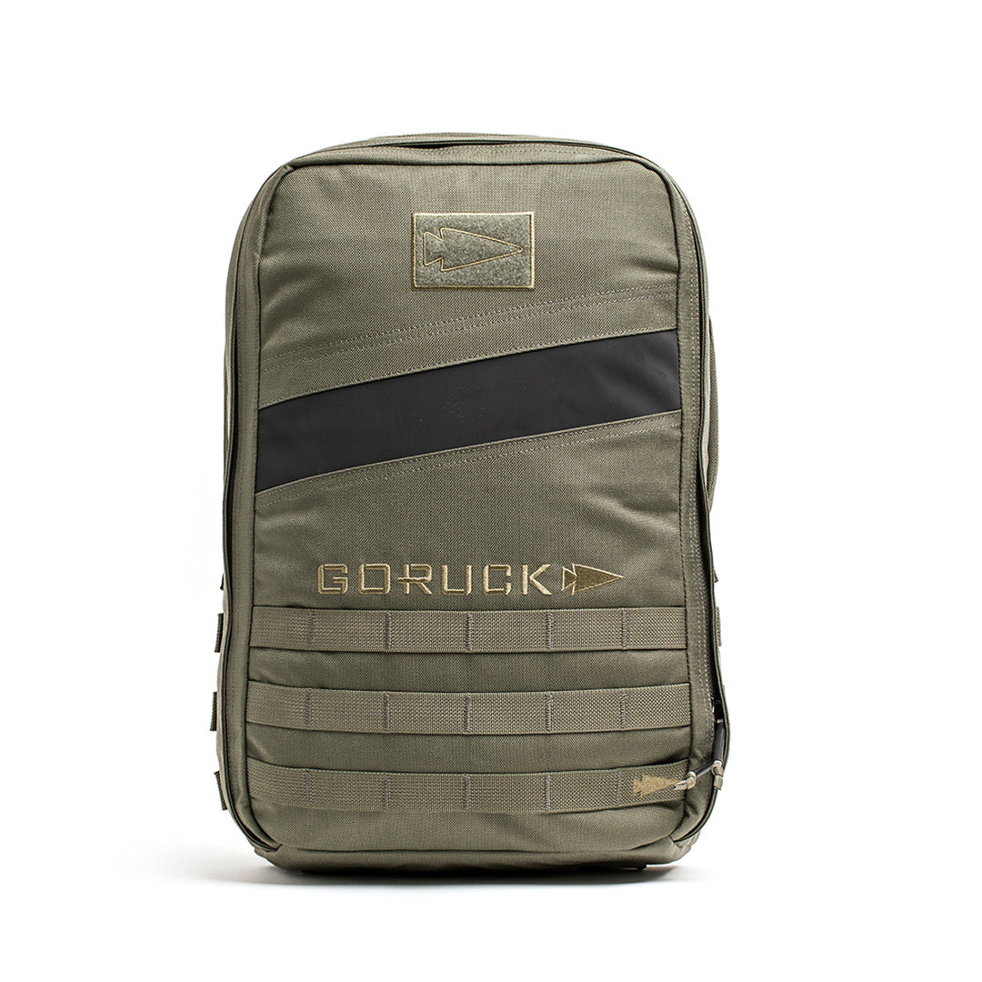 The olive green Rucker 4.0 by GORUCK boasts a stylish black diagonal stripe and the classic "GORUCK" logo on its front pocket, ideal for all your rucking adventures.