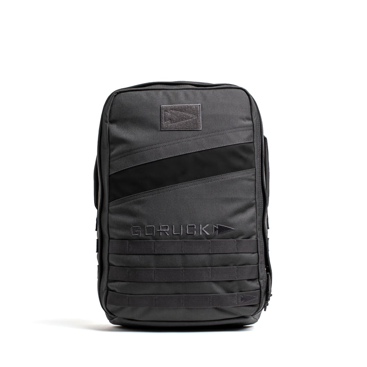 A GORUCK Rucker 4.0 black rucking backpack stands upright on a white background.