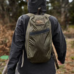 GORUCK Ranger Green packable backpack worn outdoors in rain, durable rucking gear