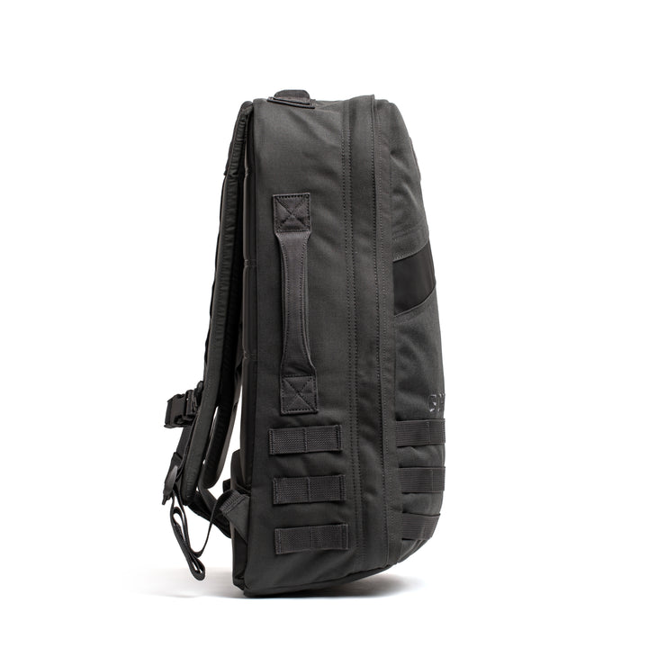 The GORUCK Rucker 4.0 backpack in black is shown from the side with MOLLE webbing and a top handle, set against a white background.