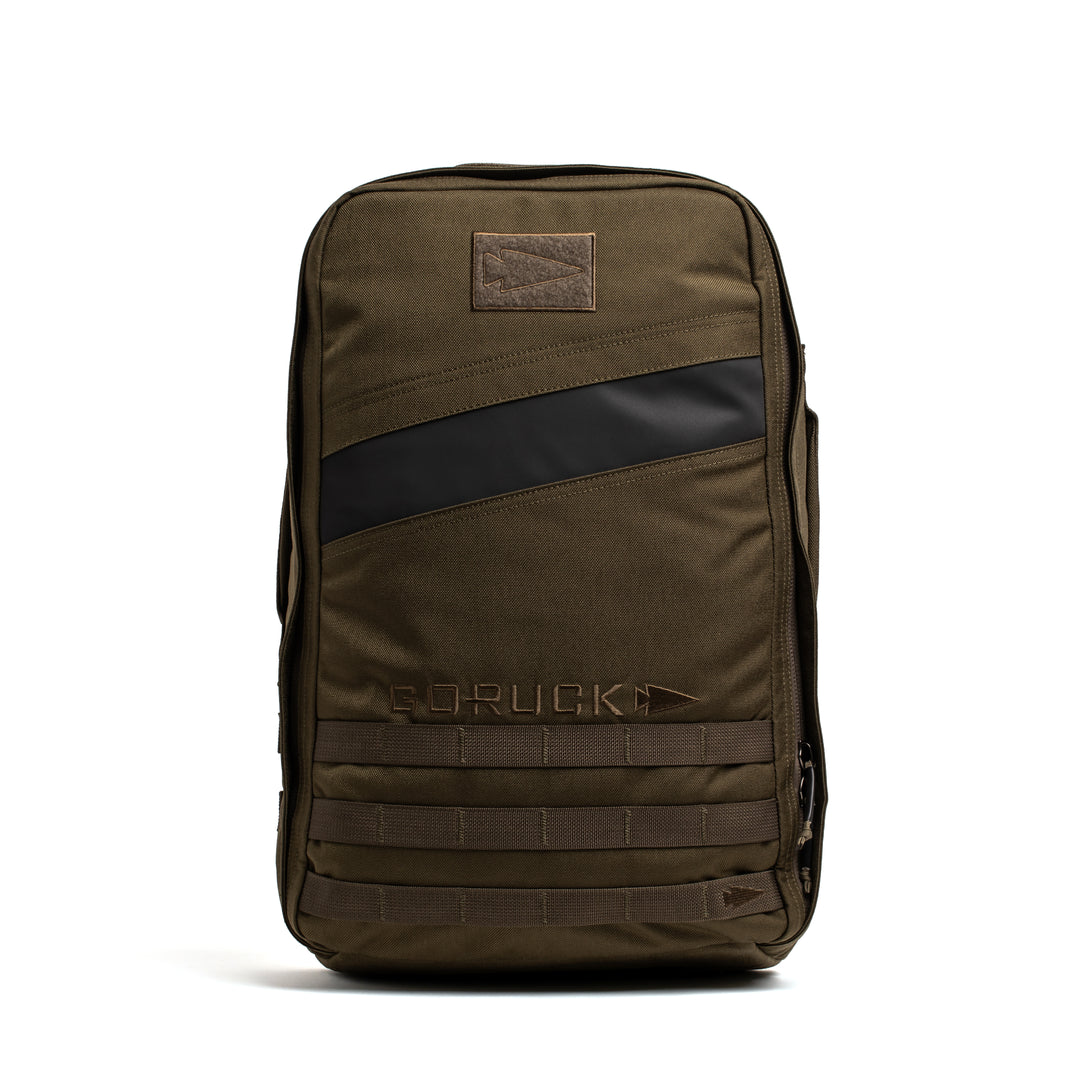 The GORUCK Rucker 4.0 backpack features an olive green design with a black diagonal stripe, front patch, and MOLLE webbing—making it the perfect durable rucking gear for your toughest adventures.