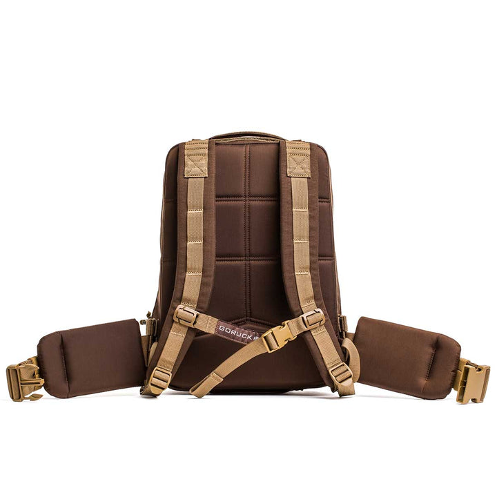 The GORUCK Rucker 4.0 bag, featuring padded shoulder straps and a waist belt, is displayed from the back against a white background.