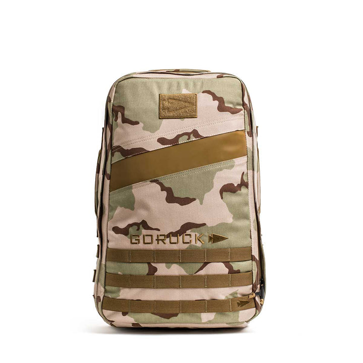 The GORUCK Rucker 4.0 backpack, featuring a camouflage design with tan accents, is displayed upright against a white background.