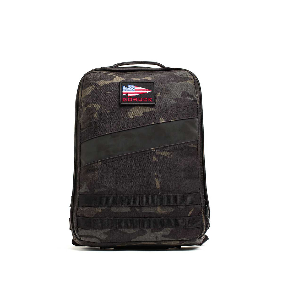 The GORUCK Rucker 4.0 is a black camo rucksack featuring a GORUCK patch and American flag on the front, ideal for rucking or daily use.