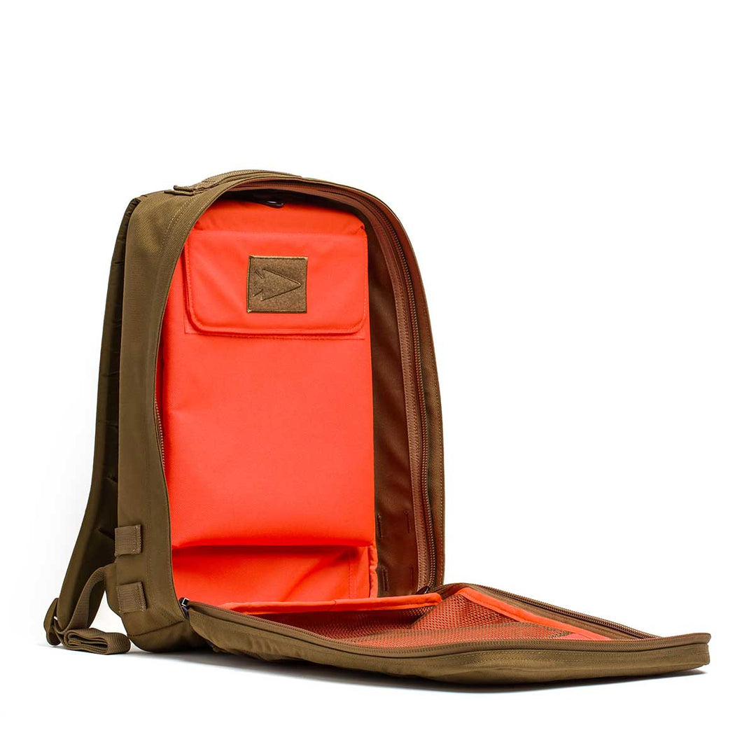 The GORUCK Rucker 4.0 backpack is shown with its front unzipped, revealing a bright orange interior and mesh pocket—ideal for carrying Ruck Plates on your next rucking adventure.