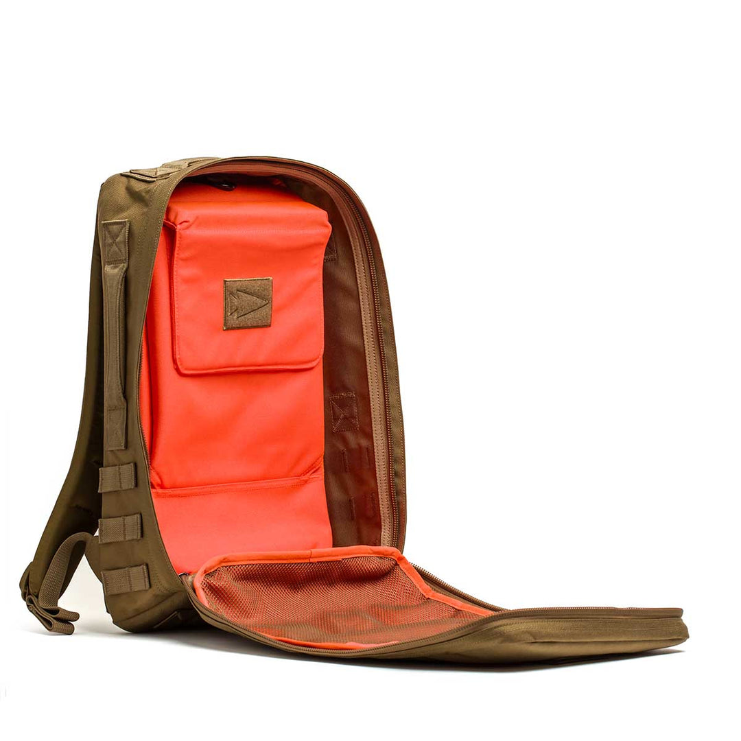 The GORUCK Rucker 4.0 backpack features a bright orange interior, mesh pocket, and dedicated space for Ruck Plates in its main compartment—ideal for rucking adventures.