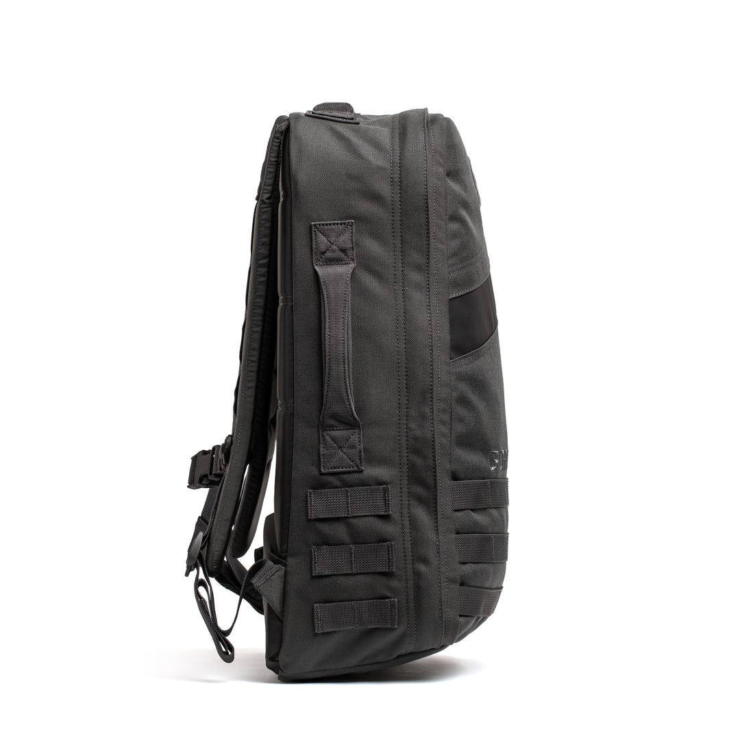 Side view of the GORUCK Rucker 4.0 in black, featuring padded straps and multiple webbing loops—ideal for rucking or carrying Ruck Plates—displayed on a white background.