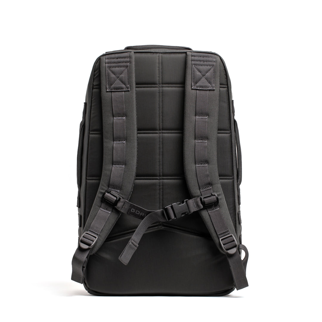 The GORUCK Rucker 4.0, shown from the back against a white background, is a black rucksack featuring padded shoulder straps and a chest buckle—perfect for rucking.