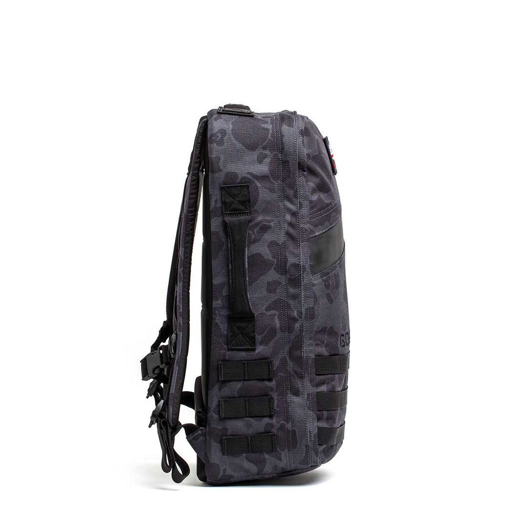 Side view of the GORUCK Rucker 4.0 in dark gray camo with black straps and multiple webbing loops—ideal for rucking adventures.