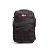The Rucker 5.0 is a black tactical rucksack featuring an American flag patch, front MOLLE webbing, and built-in lumbar support—ideal for rucking or daily use, shown upright against a white background.