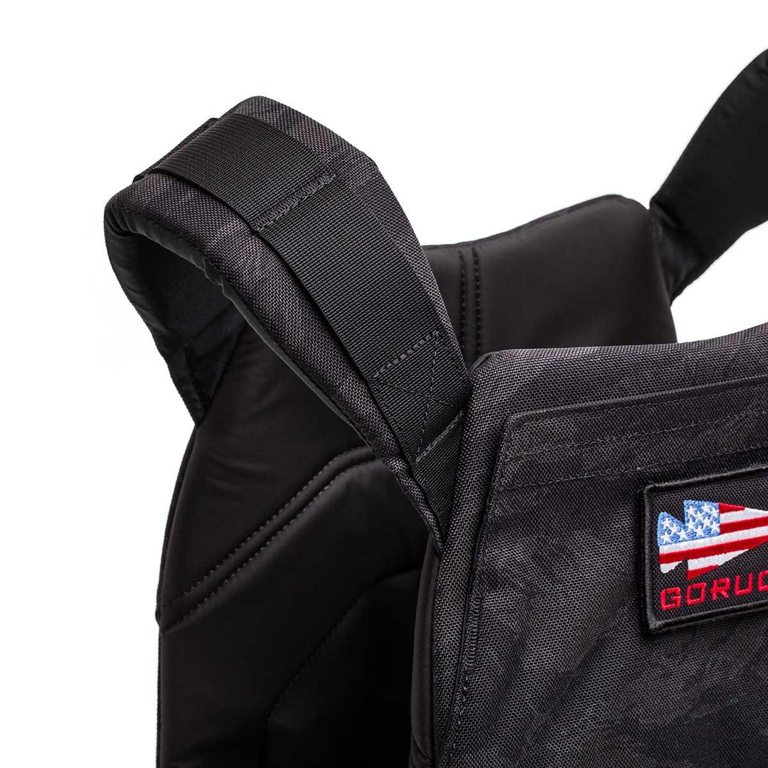 GORUCK black weight vest with padded straps and American flag patch, closeup view
