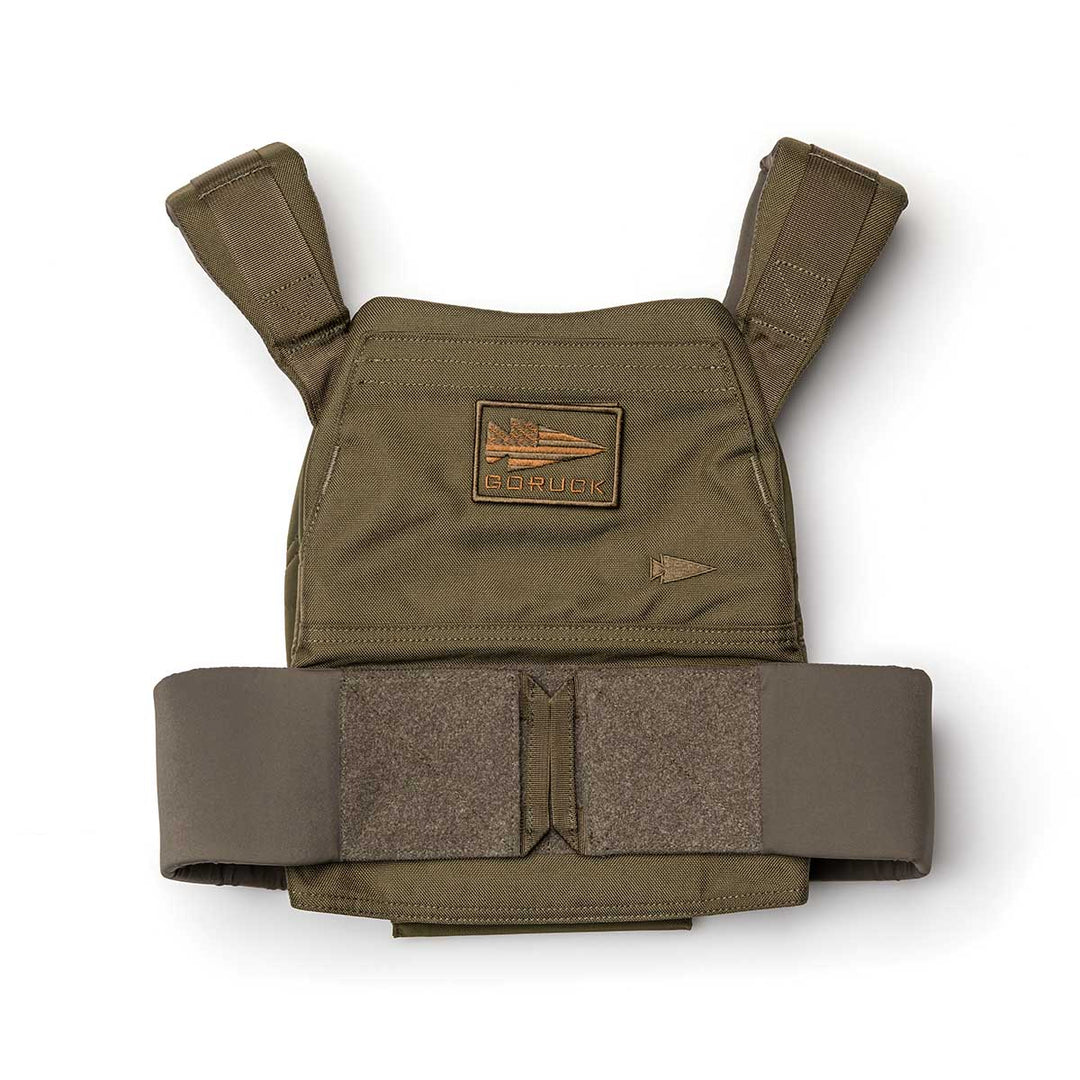 The Rucking Weight Vest in olive green features a Velcro patch, adjustable shoulder straps, and Curved Ruck Plate compatibility, designed for rucking and shown laid flat on a white background.