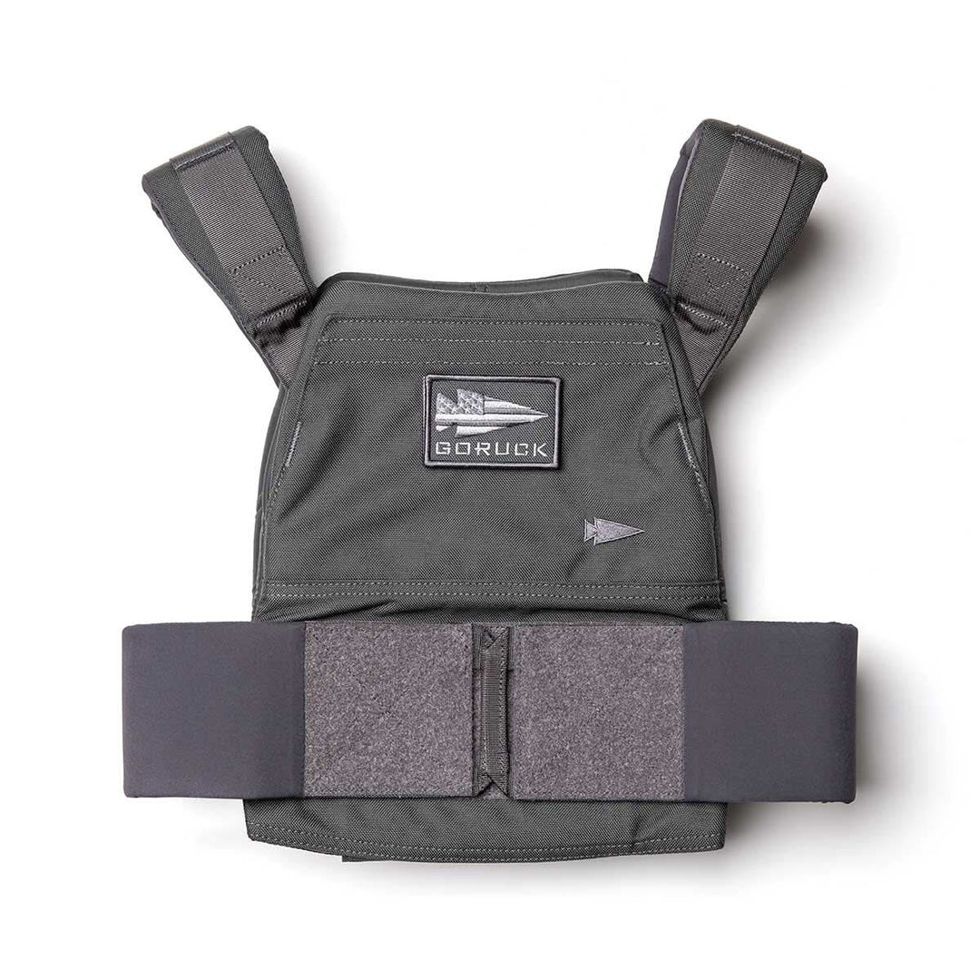 The Rucking Weight Vest is a black tactical vest with padded straps and a GORUCK patch, designed for rucking and compatible with Curved Ruck Plates, shown on a white background.