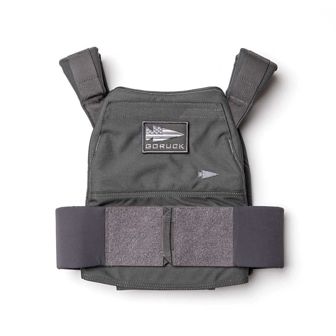 The Rucking Weight Vest is a gray tactical vest with shoulder straps and a front GORUCK patch, designed for rucking. It features space for Curved Ruck Plates and is shown on a white background.