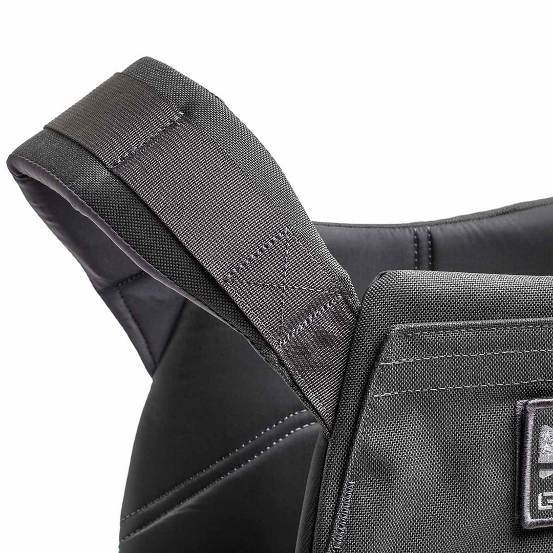 Close-up of a padded black shoulder strap on the Rucking Weight Vest, featuring visible stitching and designed for comfort during workouts with Curved Ruck Plates.