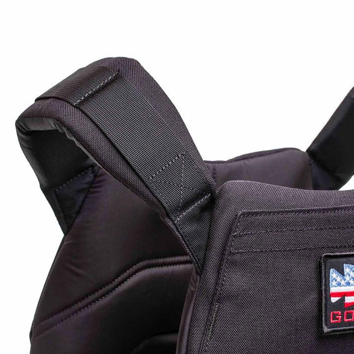 Close-up of the Rucking Weight Vest in black with visible stitching and a small American flag patch on the front, designed for rucking and compatible with Curved Ruck Plates.