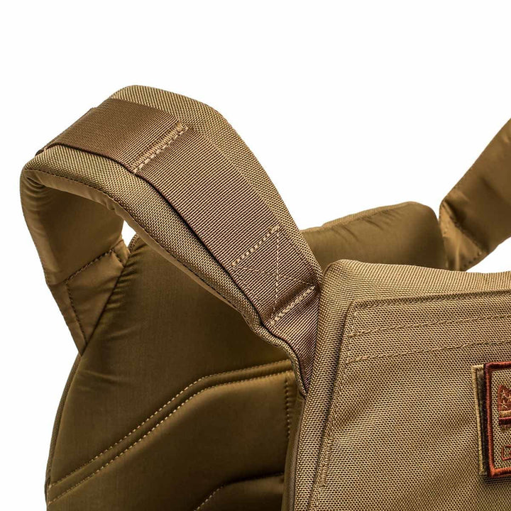 Close-up of a padded, tan fabric shoulder strap on the Rucking Weight Vest with visible stitching and quilted details—designed for comfort and support during weighted training.