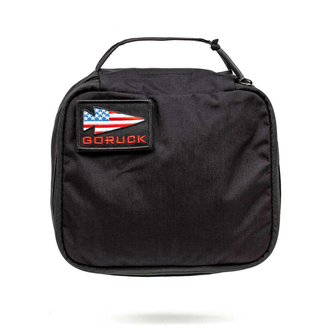 The GORUCK Shadow Pockets are black Cordura zippered pouches with a handle for durable gear organization, finished with a GORUCK patch and an American flag arrow patch.