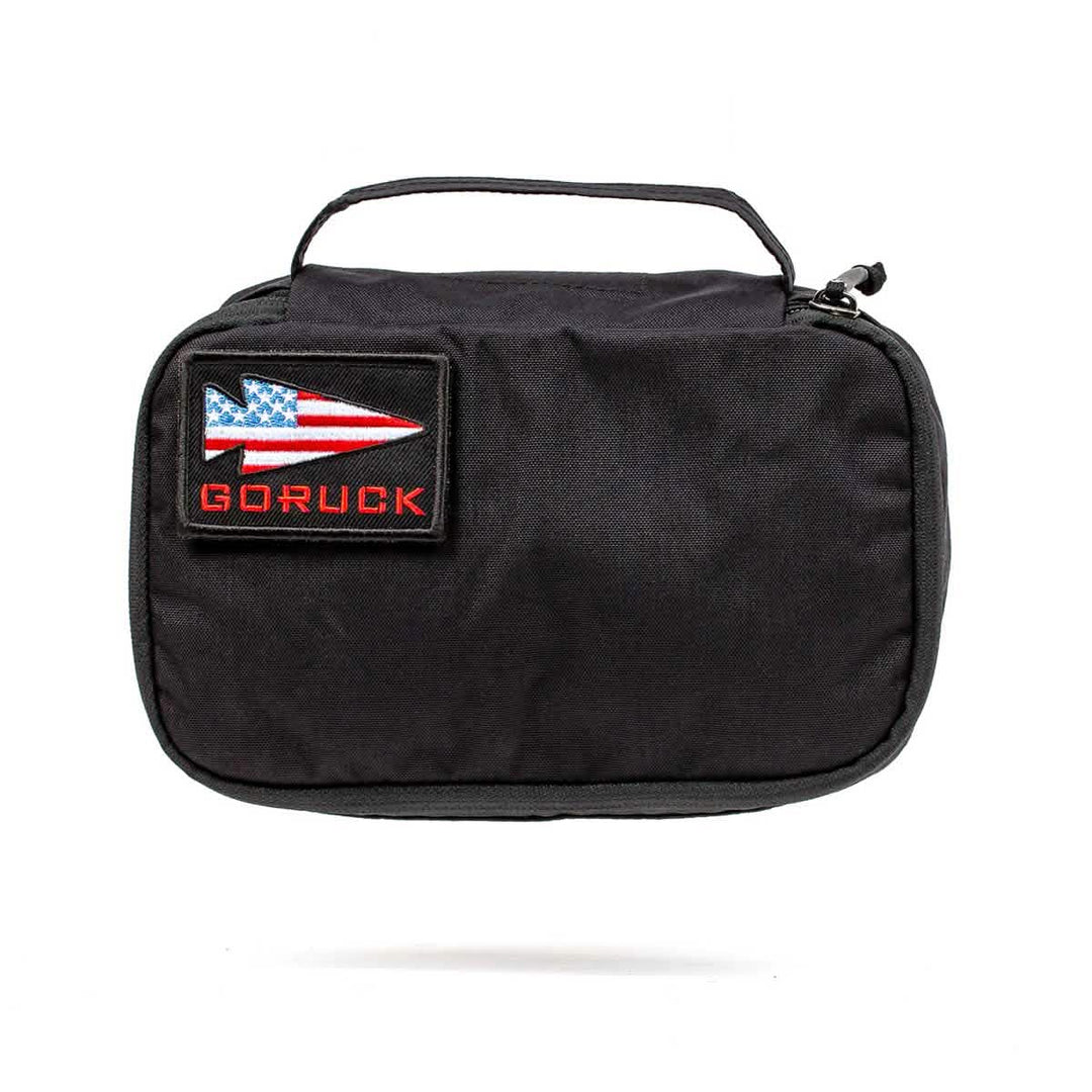 The GORUCK Shadow Pockets are black Cordura pouches with a top handle and a patch showing a red spear and U.S. flag—ideal for organizing your essential gear.
