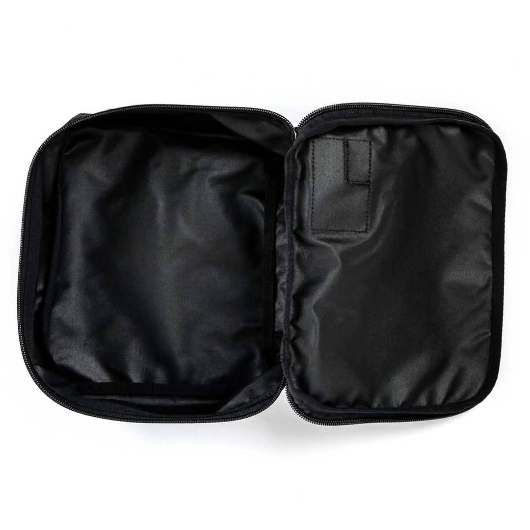 A black GORUCK Shadow Pockets Cordura zippered pouch with a smooth interior, ideal for organizing gear, lies open and empty on a white background.