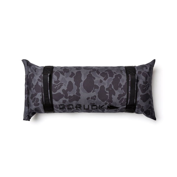 The GORUCK Simple Training Sandbag features a black and gray camo design, sturdy handles, and the "GORUCK" logo on top—built tough for any home gym and backed by the Scars Lifetime Guarantee.