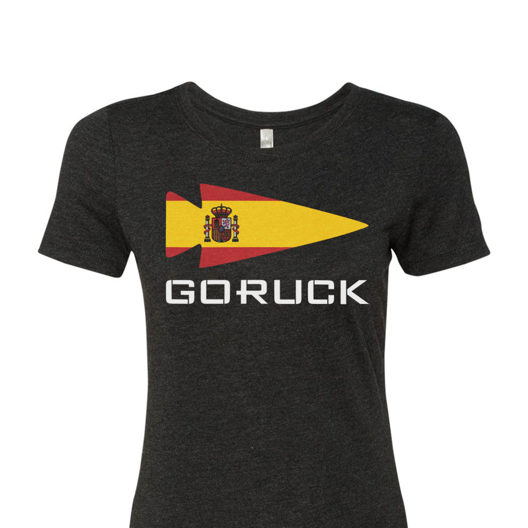 The Women's T-shirt - Rep Your Country, from GORUCK EU, is a premium tri-blend gray garment featuring a striking Spanish flag design next to the word "GORUCK" in bold white letters, seamlessly combining comfort and style to proudly represent your home country.