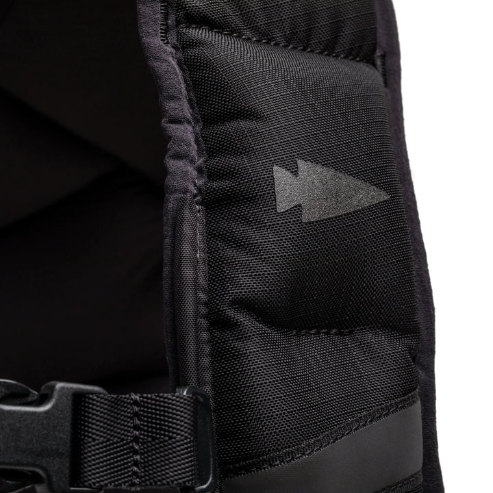 Close-up of black GORUCK rucksack strap with arrowhead logo and durable nylon stitching