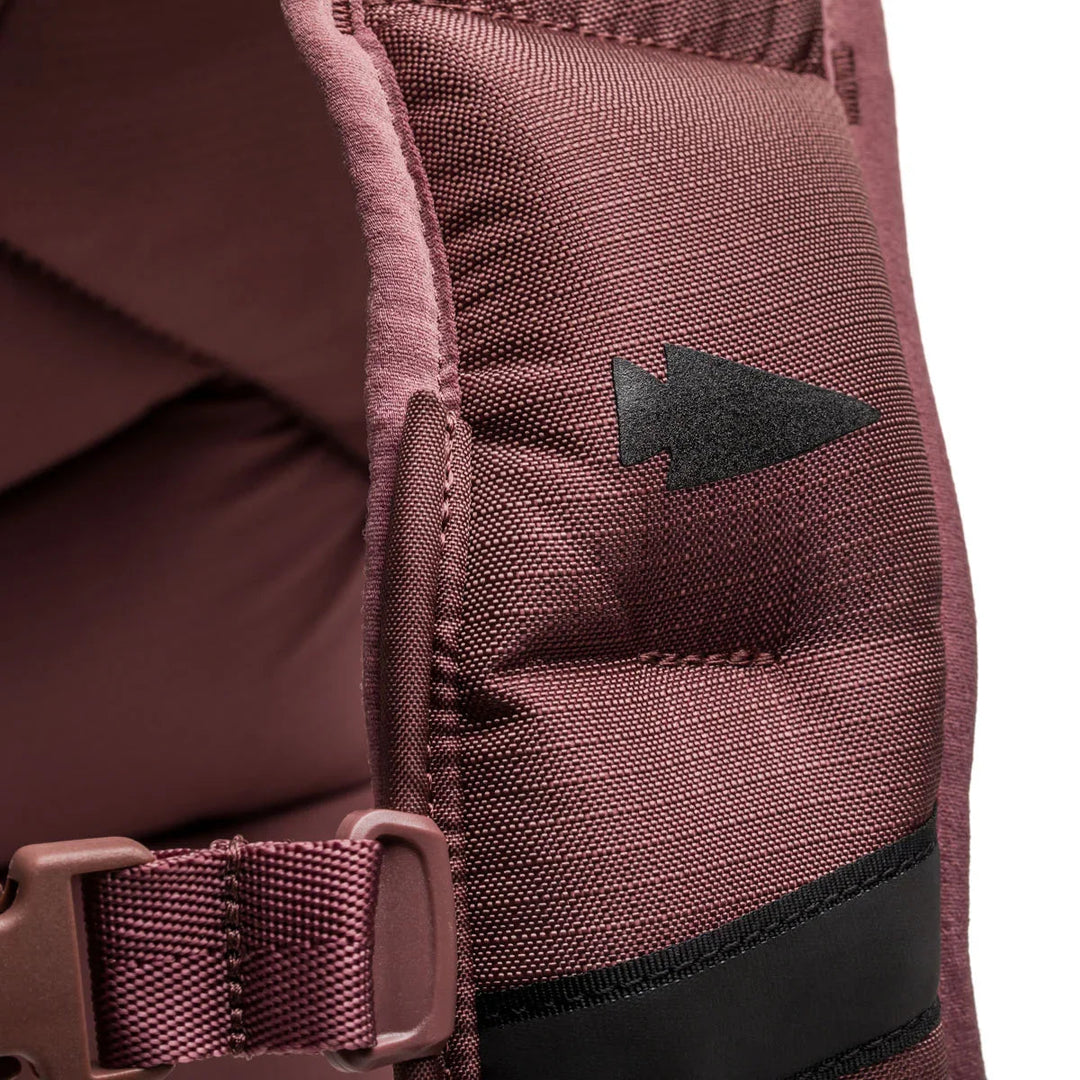 Close-up of GORUCK rucksack shoulder strap with durable fabric and arrowhead logo