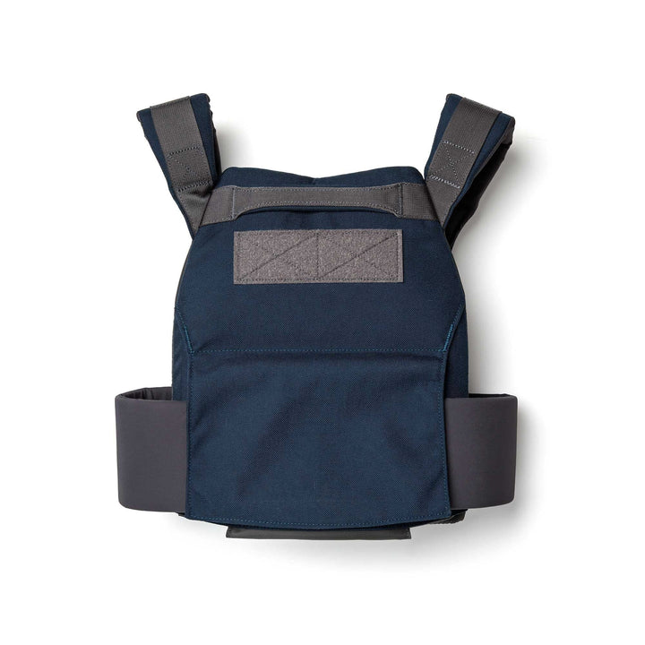 The Rucking Weight Vest in navy blue and gray features padded straps and a waist belt, designed for training with curved ruck plates. Shown on a white background.