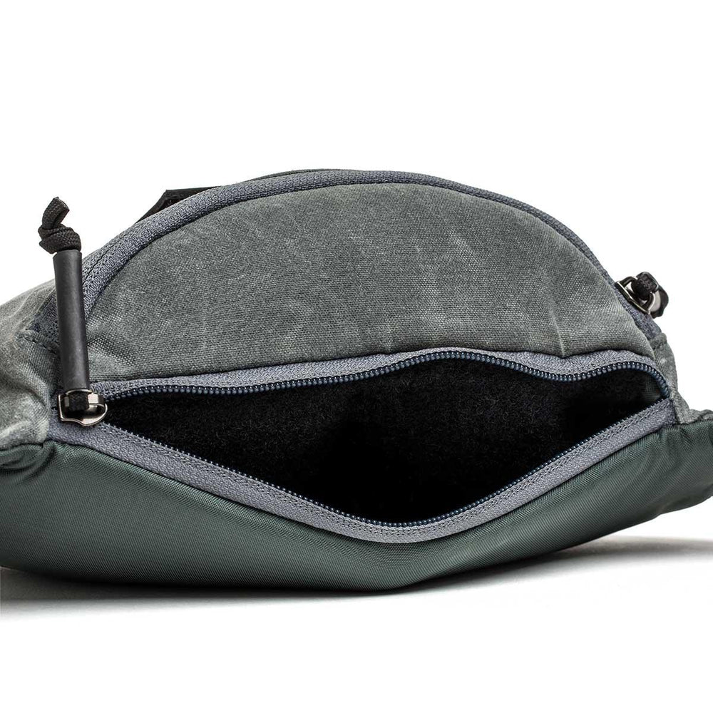 GORUCK tactical fanny pack in slate waxed canvas with open zipper and spacious interior