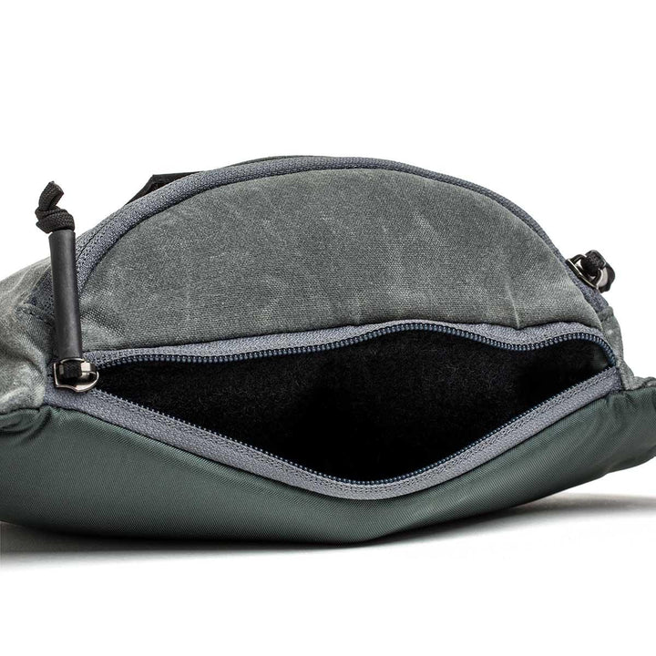 GORUCK tactical fanny pack in slate waxed canvas with open zipper and spacious interior