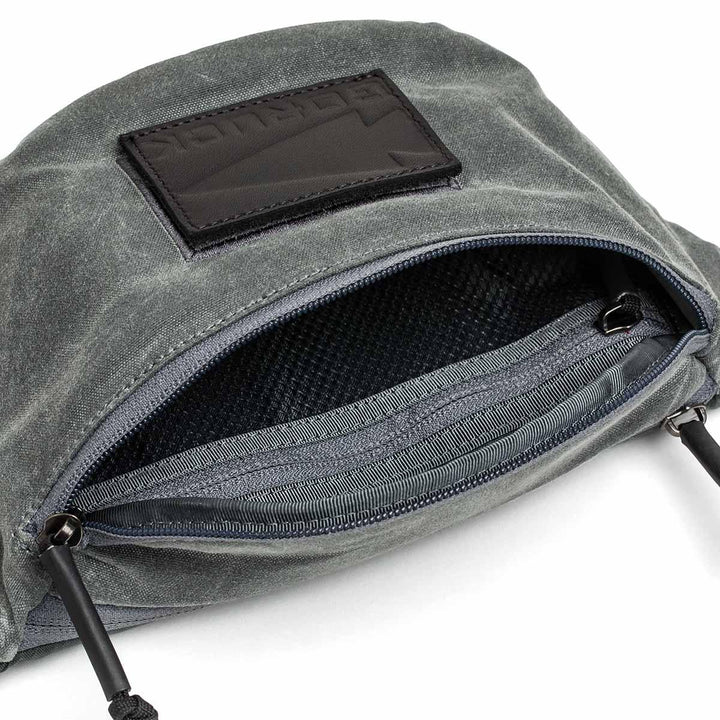 GORUCK tactical fanny pack in waxed slate canvas with open zippered compartment