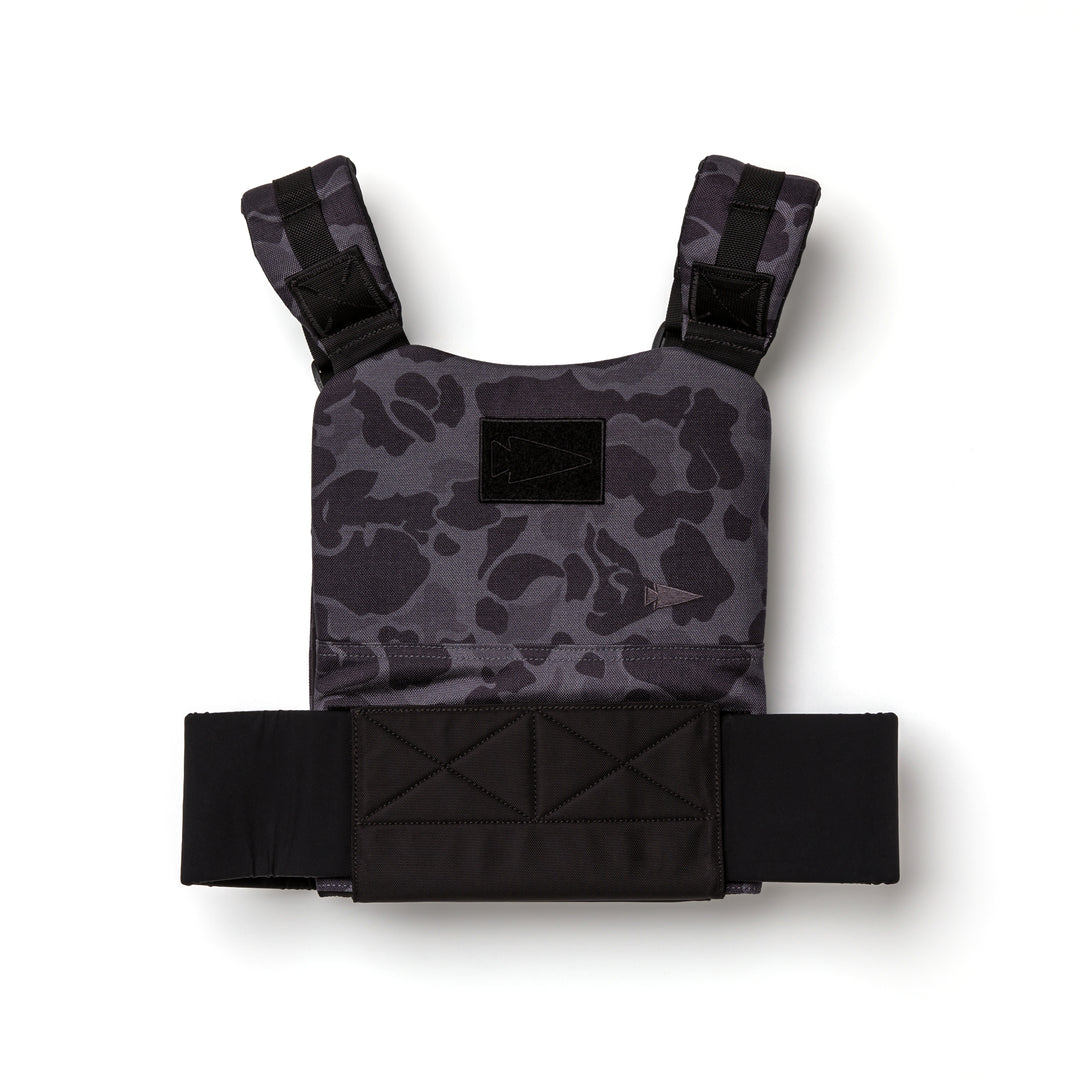 The GORUCK Training Weight Vest 2.0 features a dark camo pattern, broad shoulder straps, and a wide waistband—ideal for training or use with ruck plates—shown against a white background.