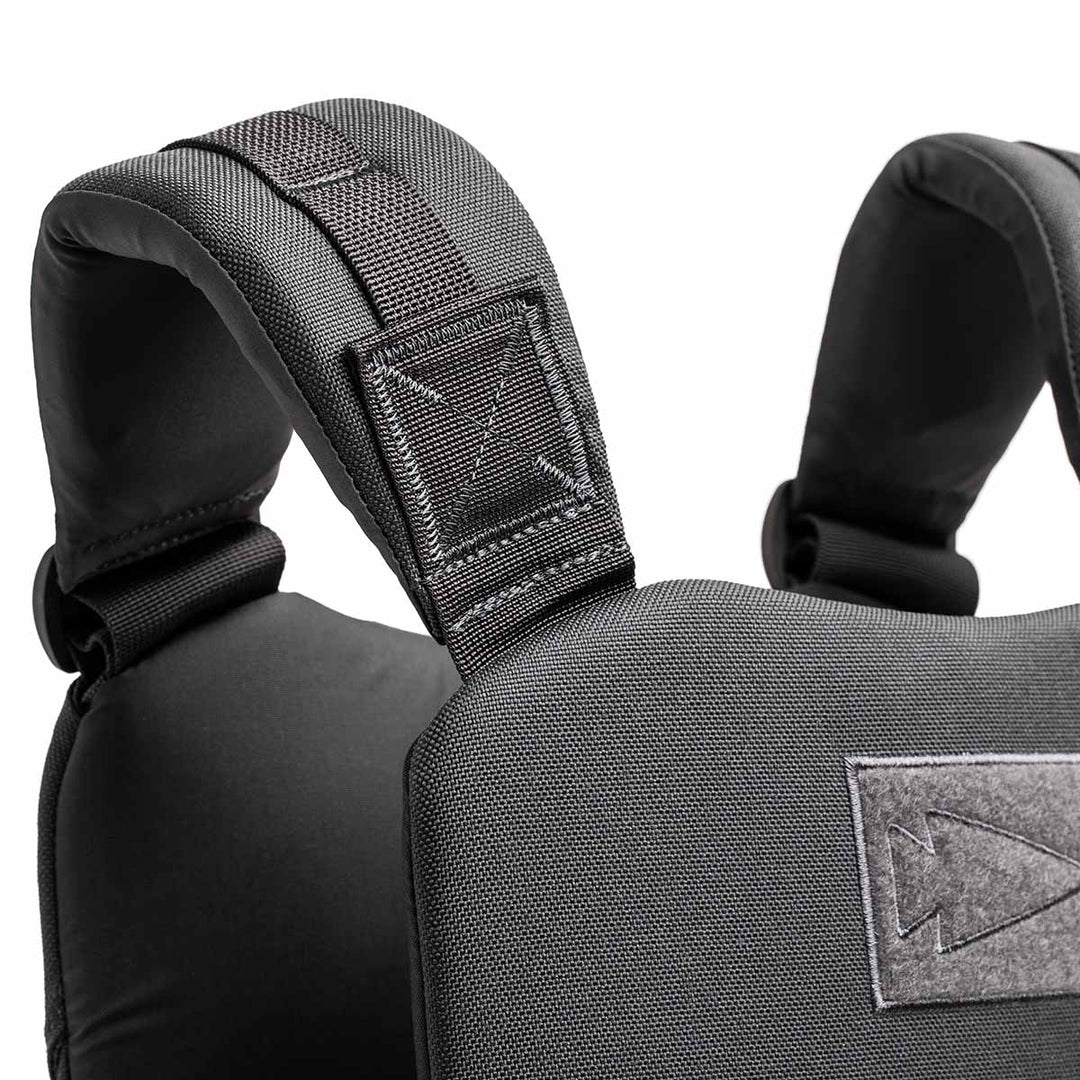 Close-up of padded black shoulder straps on the adjustable GORUCK Training Weight Vest 2.0, shown against a white background.
