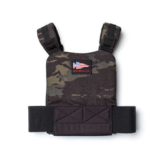 The Training Weight Vest 2.0 features camouflage design, black straps, and an American flag patch labeled "GORUCK" on the chest, built to securely hold ruck plates for added resistance during training sessions.