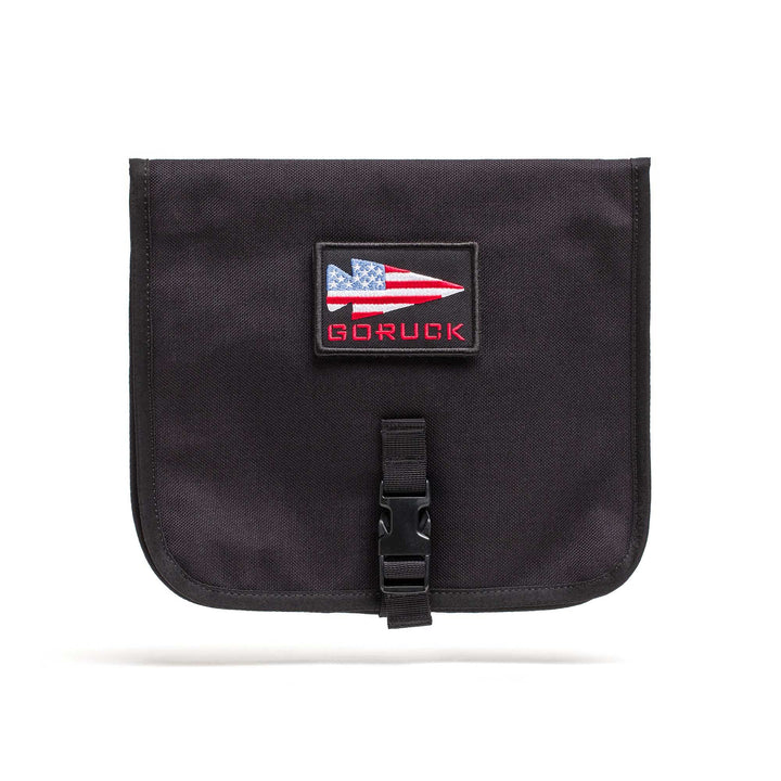 The Wire Dopp is a black pouch with an American flag patch and "GORUCK" text, front buckle closure—ideal as a travel organizer or cable pouch for your EDC essentials.