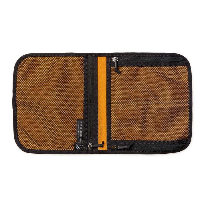 The Wire Dopp is an open brown zippered mesh travel organizer with two compartments and black trim, shown lying flat on a white background—ideal for keeping your EDC essentials organized.
