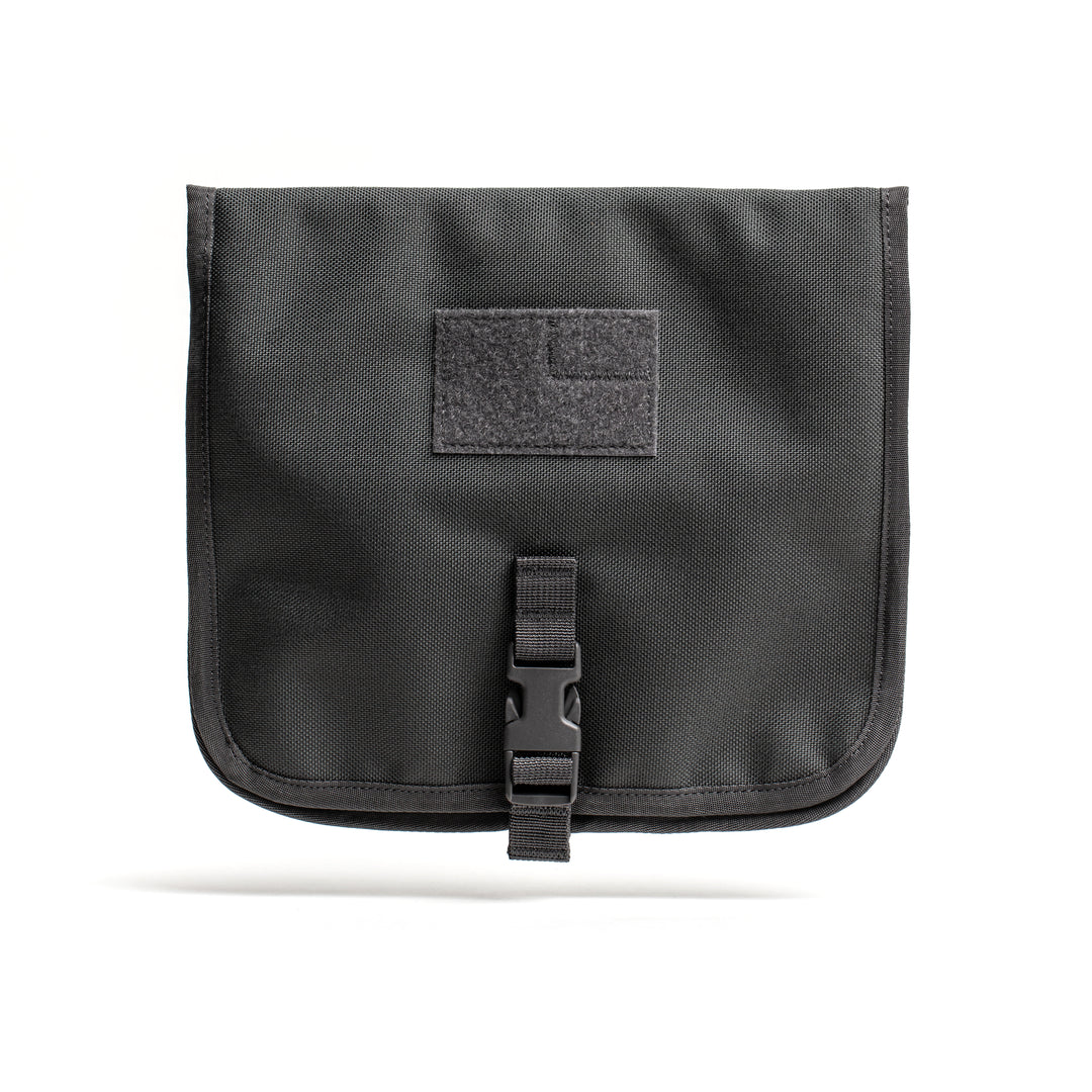 The GORUCK Wire Dopp features a black nylon pouch with buckle closure and a front hook-and-loop patch, perfect for keeping your tech cables and travel essentials organized.