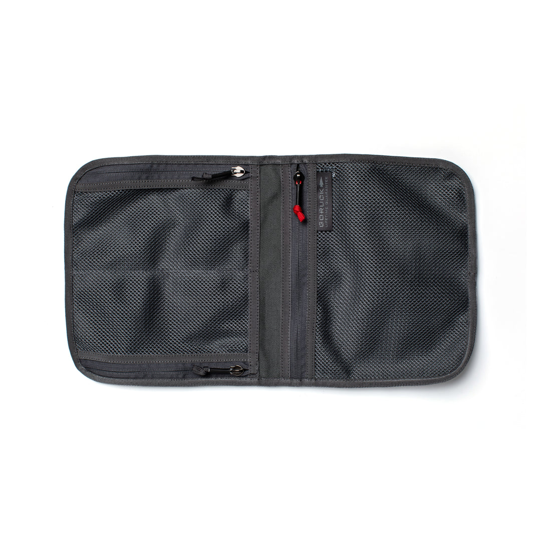 The GORUCK Wire Dopp zippered travel pouch features mesh compartments for organized carry of essentials and is shown open and empty on a white background.