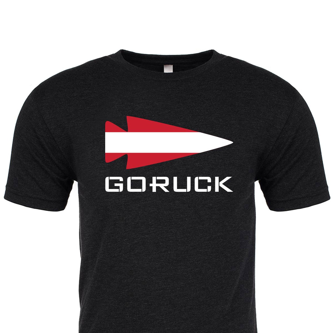 The T-shirt - Rep Your Country from GORUCK EU is a premium tri-blend black t-shirt that showcases the bold "GORUCK" text along with an eye-catching red and white arrowhead logo on the front.